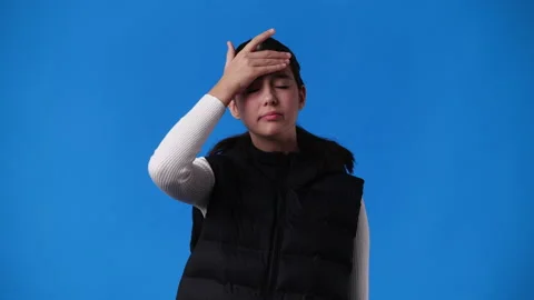 4k slow motion video of one girl feeling bad over blue background. Stock Footage 230009734