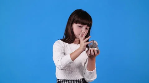 4k slow motion video of one girl with Christmas ball over blue background. Video stock 230165335