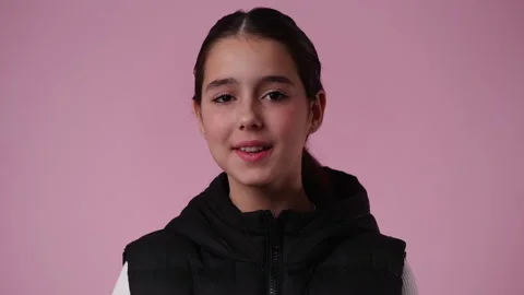 4k slow motion video of one girl showing silence sign on pink background. Stock Footage 230258544