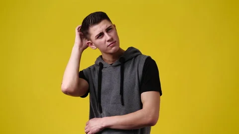 4k slow motion video of one man with thoughtful facial expression on yellow Stock Footage 230411570