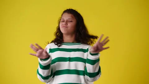 4k slow motion video of one girl gesturing no over yellow background. Stock Footage 230673717
