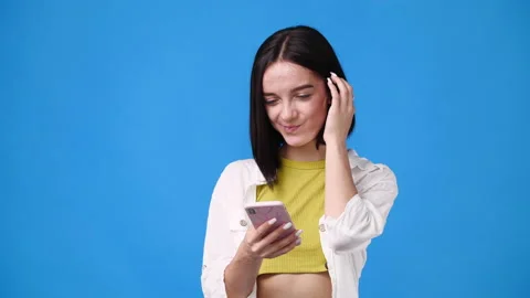 4k slow motion video of one girl sending message with positive facial expression Stock Footage 230923359
