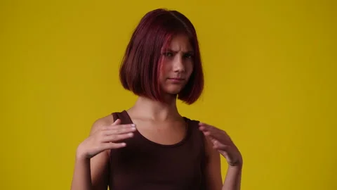 4k slow motion video of one girl gesturing no on yellow background. Stock Footage 230926461