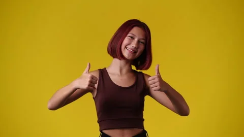 4k slow motion video of one girl pointing at the camera and showing thumbs up Stock Footage 231146559
