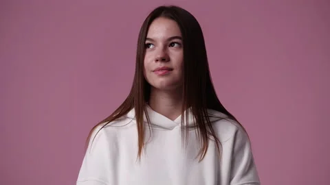 4k slow motion video of one girl showing silence sign over pink background. Stock Footage 231343961