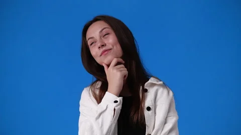 4k slow motion video of one girl thinking about something on blue background. Stock Footage 231389896