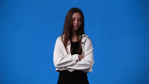 4k slow motion video of one girl with negative facial expression over blue Stock Footage 231390984