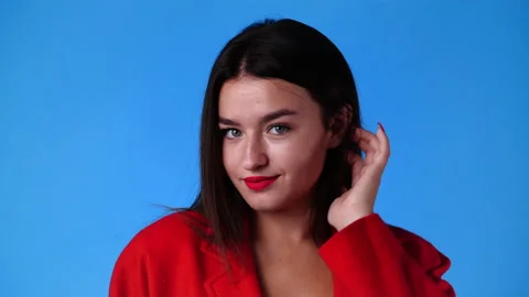 4k slow motion video of one girl posing for a video over blue background. Stock Footage 231405805