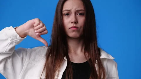 4k slow motion video of one girl with negative facial expression showing thumb Stock Footage 231629161