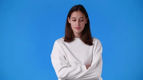 4k slow motion video of one girl with negative facial expression over blue Stock Footage 233105185
