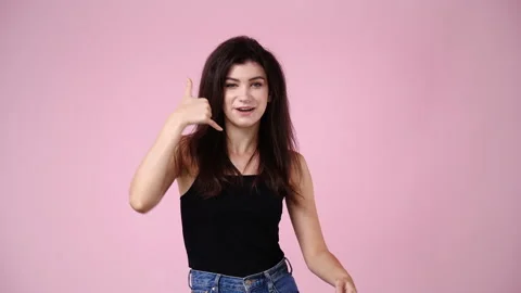 4k slow motion video of one girl asks to call someone over pink background. Stock Footage 233118255