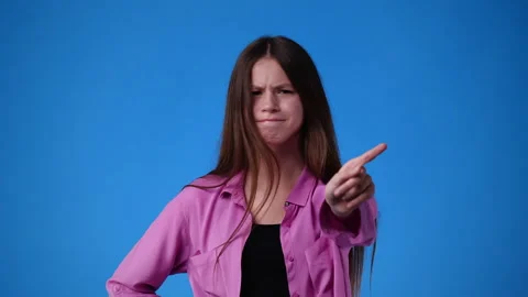 4k slow motion video of one girl who responds negatively to something over blue Stock Footage 233653282