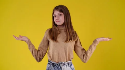4k slow motion video of one girl doubts and doesn't know what to do over yellow Stock Footage 233723066
