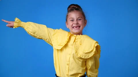 4k slow motion video of one young girl who pointing his finger to the left and Stock Footage 233738464