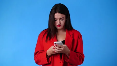4k slow motion video of one girl sending messages on blue background. Video stock 234320483