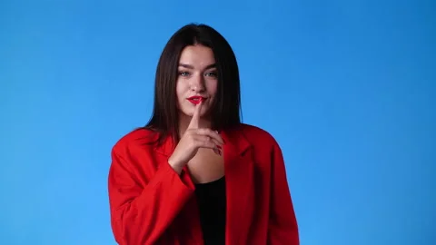 4k slow motion video of one woman looks around and showing silence sign over Video stock 234997622