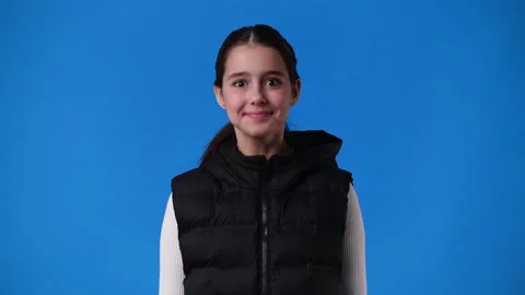 4k slow motion video of one girl agrees nodding his head over blue background. Stock Footage 235005149
