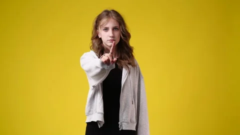 4k slow motion video of one girl stops and prohibits over yellow background. Video stock 235204792