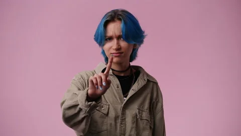 4k slow motion video of one girl who responds negatively to something over pink Stock Footage 237706792