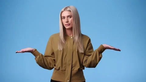 4k slow motion video of one woman doubts and waving his hands around over blue Video stock 238442795