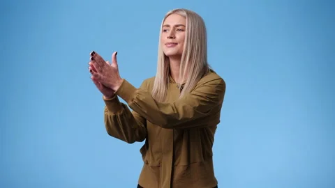 4k slow motion video of one woman claps his hands and smiling over blue Stock Footage 238443011