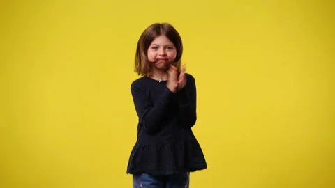 4k slow motion video of one kid who claps his hands and smiling over yellow Stock Footage 238517989