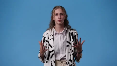 4k slow motion video of one girl who get mad over blue background. Stock Footage 238524223