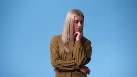 4k slow motion video of one woman doubts and thinking about something over blue Video stock 240204687