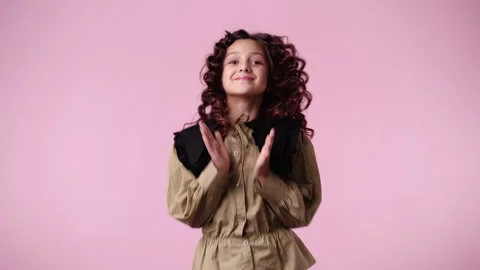 4k slow motion video of one girl who claps his hands and smiling over pink Stock Footage 240319139