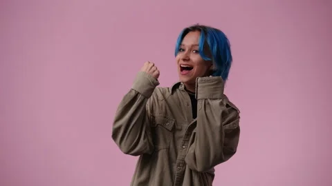 4k slow motion video of one girl who emotionally rejoices over pink background. Stock Footage 241368314