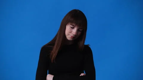 4k slow motion video of one girl who thinking of something over blue background. Stock Footage 241374214