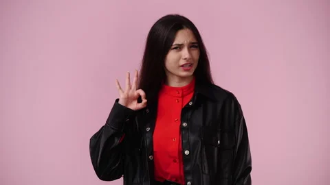 4k slow motion video of one girl showing OK sign in pink background. Stock Footage 241427259