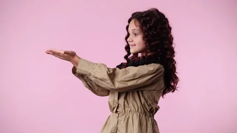 4k slow motion video of one young girl who shows something in his hands over Stock Footage 243371585