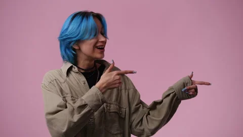4k slow motion video of one girl who points to the right side over pink Stock Footage 244303915