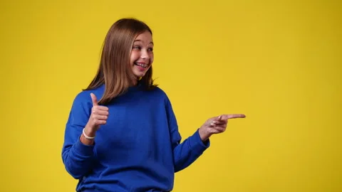 4k slow motion video of one girl who points to the right side and showing thumb Stock Footage 244486311