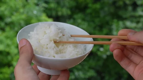4K slow motion video of picking up rice from a bowl with chopsticks. Stock Footage 313058538