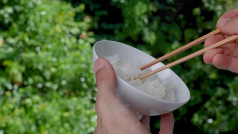 4K slow motion video of picking up rice from a bowl with chopsticks. Stock Footage 314406441