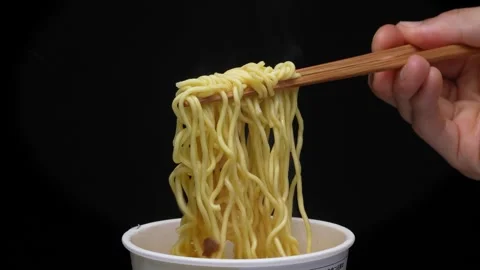 4K slow motion video of pulling up noodles with chopsticks. Video stock 283239700