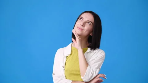 4k slow motion video of small girl thinking about something on blue background. Video stock 231226420