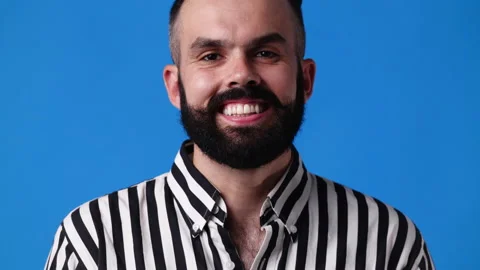4k slow motion video of smiling man over blue background. Stock Footage 227519351