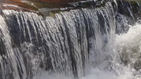 A 4K Slow Motion video of a tranquil cascading water fall and a flowing river Stock Footage 278806636
