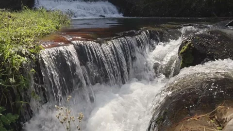 A 4K Slow Motion video of a tranquil cascading water fall and a flowing river Stock Footage 278806741