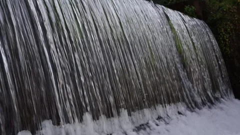 A 4K Slow Motion video of a tranquil cascading water fall and a flowing river Stock Footage 278807113
