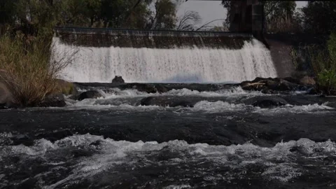 A 4K Slow Motion video of a tranquil cascading water fall and a flowing river Stock Footage 278807689