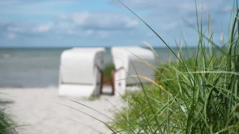 4K slow motion video of white sand and dunes grass and beach chair or strandk Stock Footage 201826461