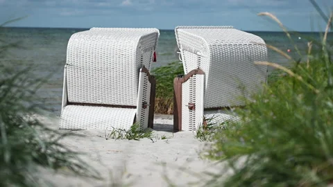 4K slow motion video of white sand and dunes grass and beach chair or strandk Stock Footage 201826839