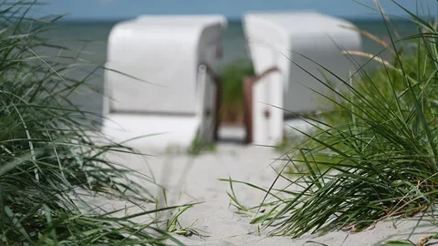 4K slow motion video of white sand and dunes grass and beach chair or strandk Stock Footage 201827046