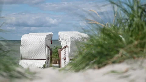 4K slow motion video of white sand and dunes grass and beach chair or strandk Stock Footage 201877900