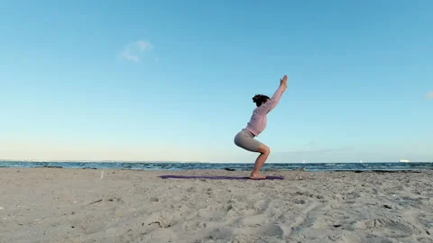 4k slow motion video of young woman doing morning yoga routine  at the beach Video stock 205584868