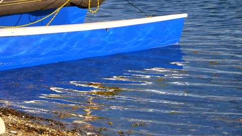 4K Slow Motion Water Reflection Blue Boat Hull, Sun Abstract Shot Video stock 80107579